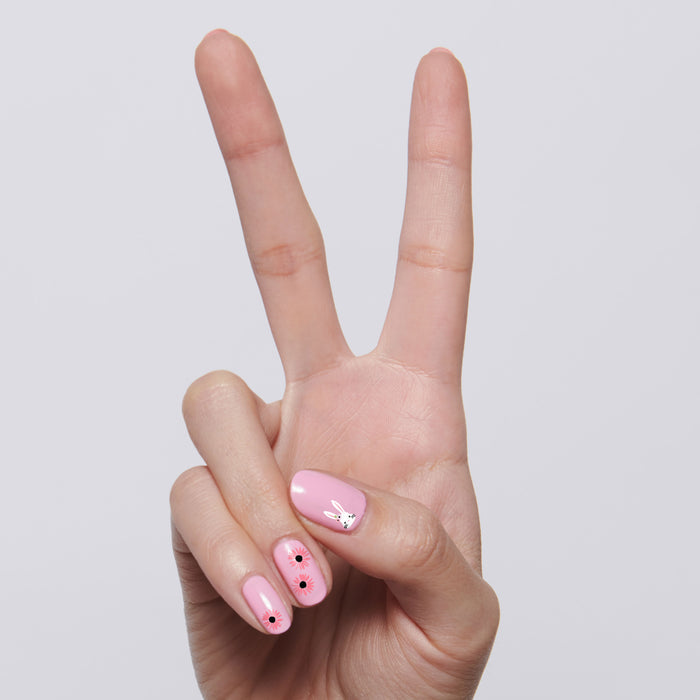 Hand showing Everyday Bouquet mani with soft pink polish and delicate peony floral nail art design