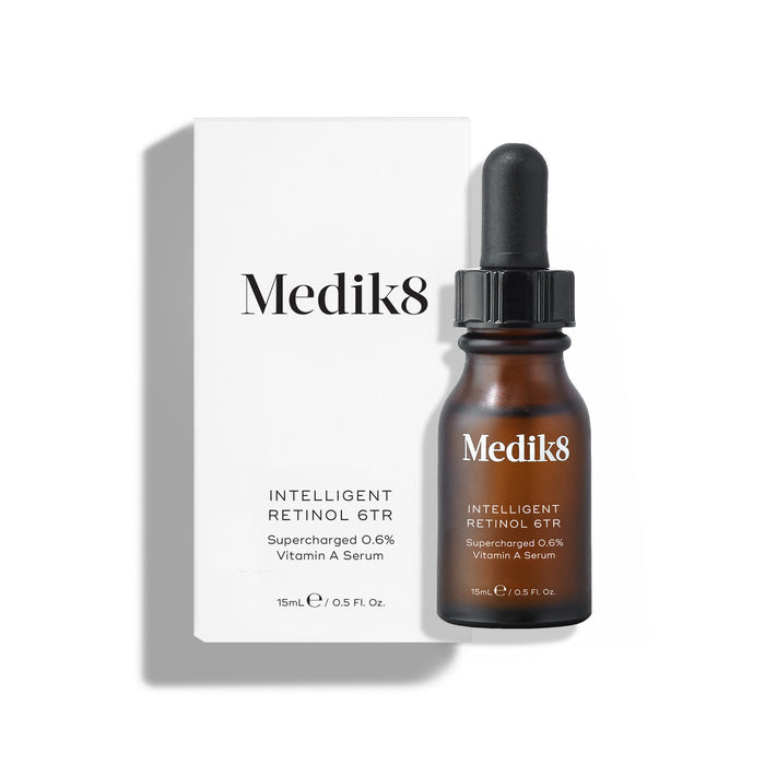 Medik8 Intelligent Retinol 6TR serum bottle stands in front of its matching white product carton on a clean white background. Text identifies the product as a 15mL "Supercharged 0.6% Vitamin A Serum."