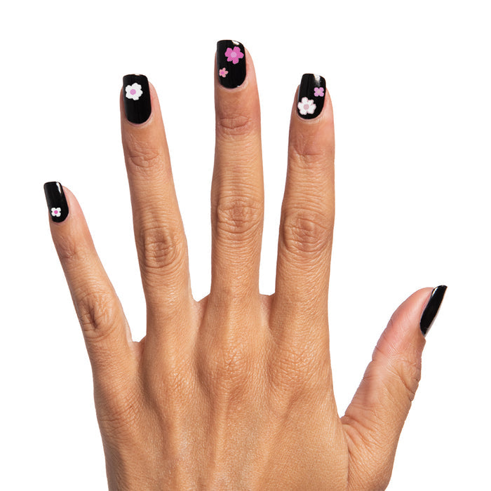 Mod Floral Stickers featuring small pink and white flower nail decals on black polished press-on nails for a stylish mani