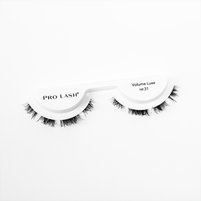 Natural volume eyelash extensions in Pro Lash Volume Luxe No.31 style featuring soft, layered lashes on a white tray.
