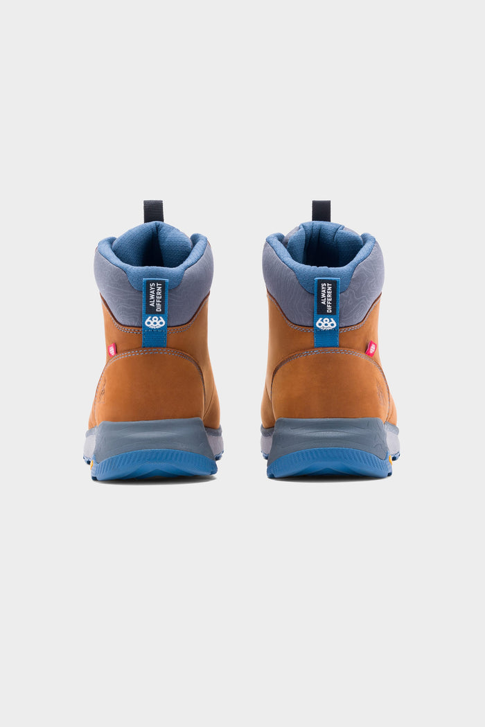The 686 x Rocky Boots Mens Summit Elite Boot, shown from the back, features brown and blue uppers, blue soles, gray and blue collars, and branded pull tabs against a plain light background.