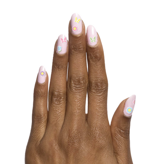 Easter Flowers & Butterflies showing hand with light pastel nails decorated with spring flowers and butterfly nail art designs