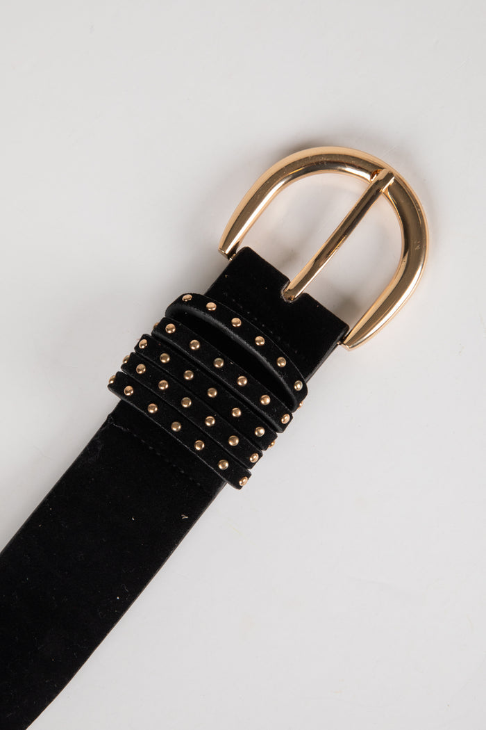 Black belt with gold studded detailing and a gold buckle on a light gray background