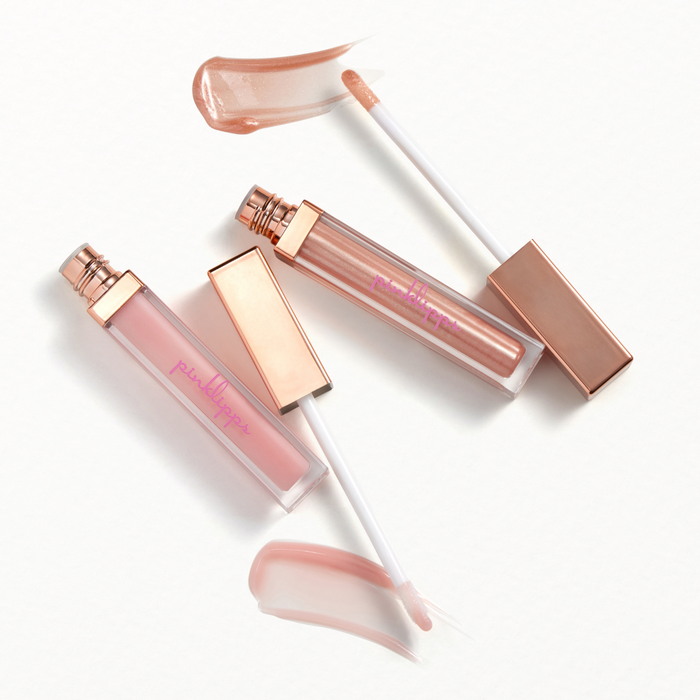 Swatch of Pink Lipps Lip Gloss Duo gloss ‘Aglow’ sheer radiant glow finish, and 'Star' rich sparkle and luminous shine, editorial studio lighting