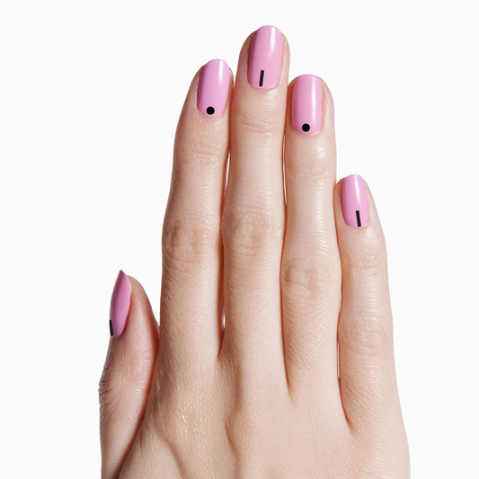 Hand with soft pink manicure featuring SIMPLE AND SHINY geometric metallic nail art stickers on fair skin tone