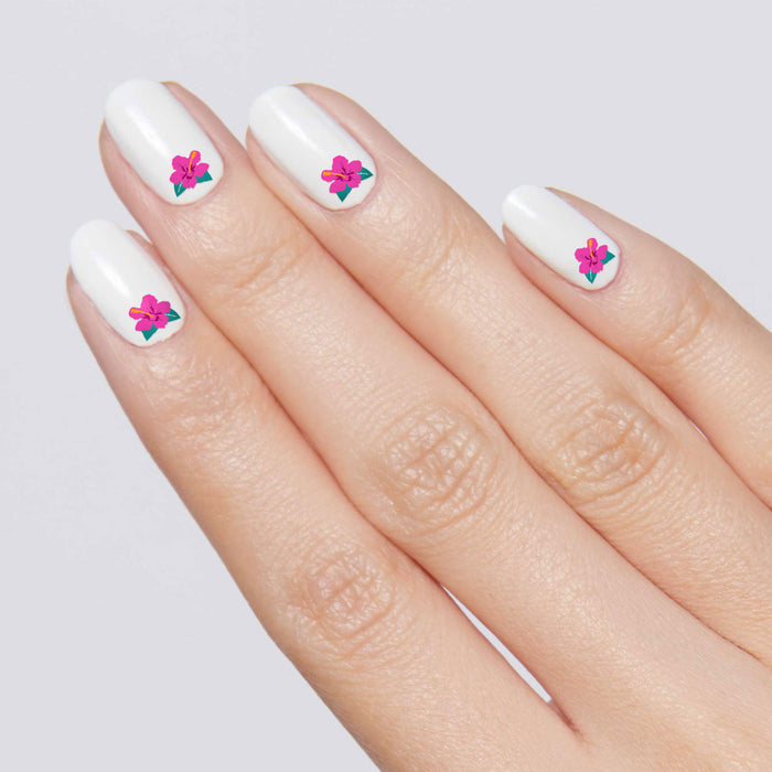 Hand with white polish and bright hibiscus floral nail art representing Tropical Vibes mani design